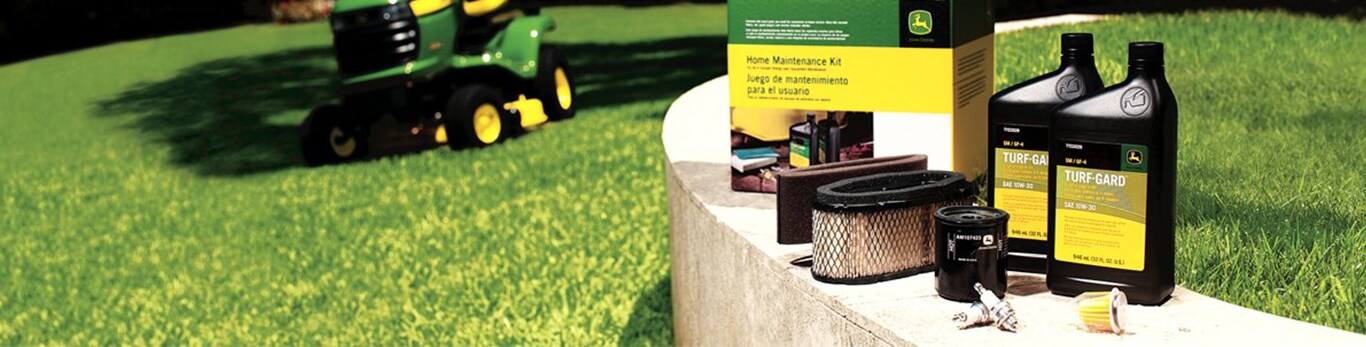 John Deere Home Maintenance Kit set out on a bench in a yard