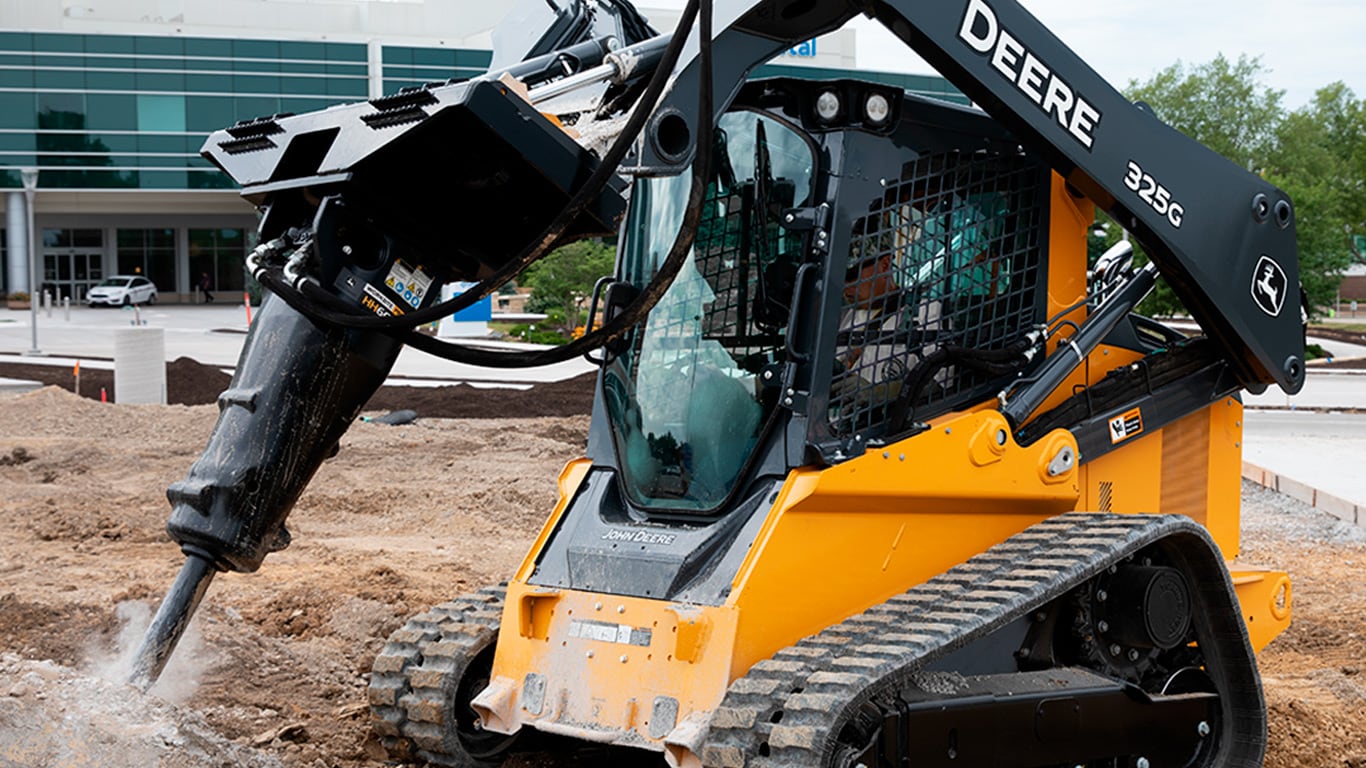 325g tracked skid steer on dirt construction site