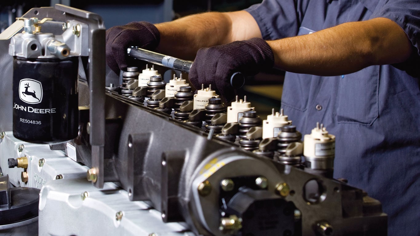 Worker assembling an engine