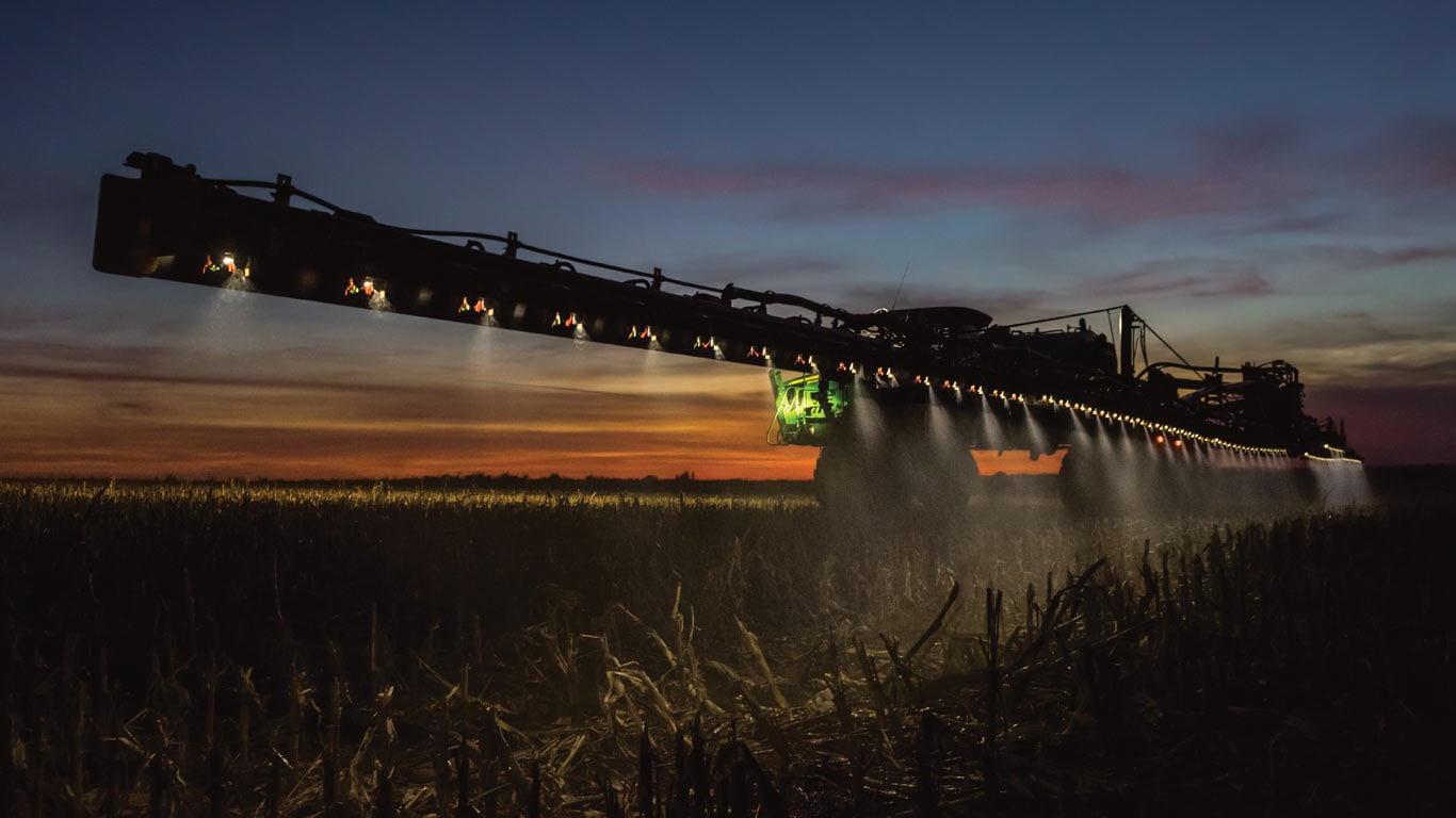 sprayer equipment on field in sunrise/sunset