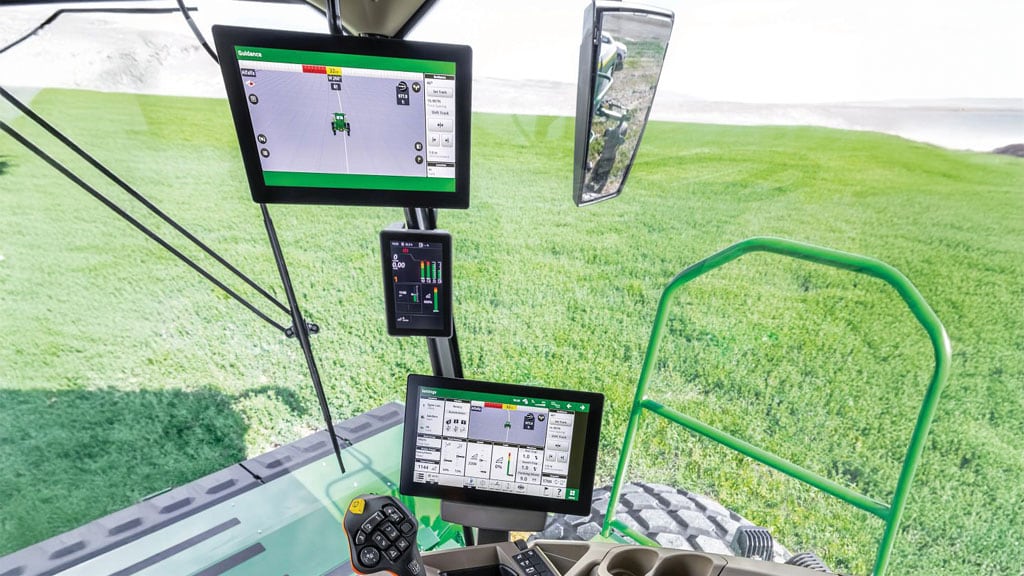 Multiple screens within the windrower cab