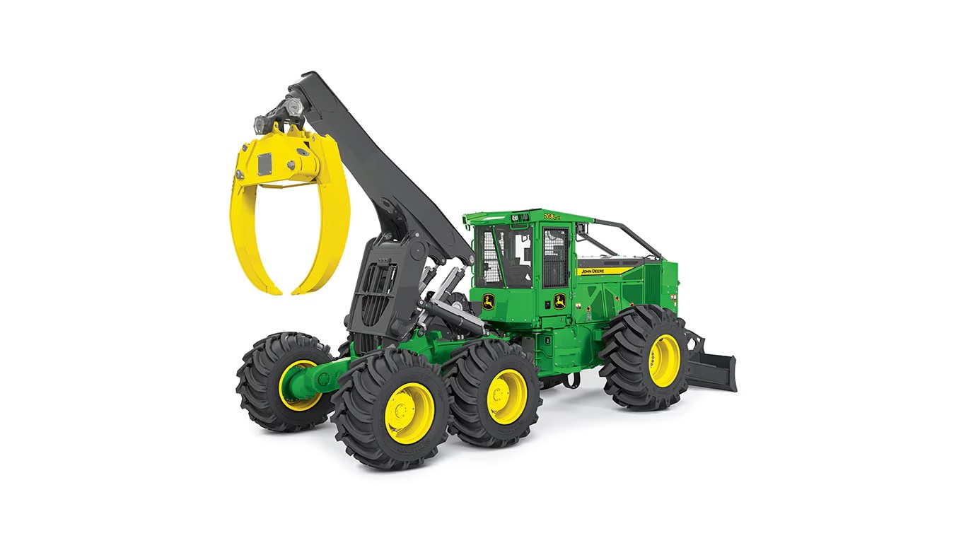 Green and yellow forestry machine with large tires and grapple arm for handling logs.